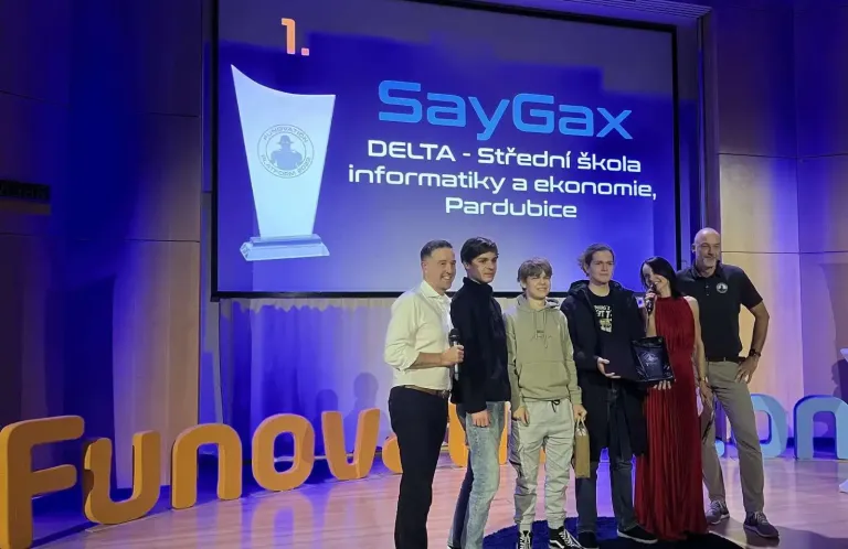 Photo of our team posing together on the stage after we were announced as the winners